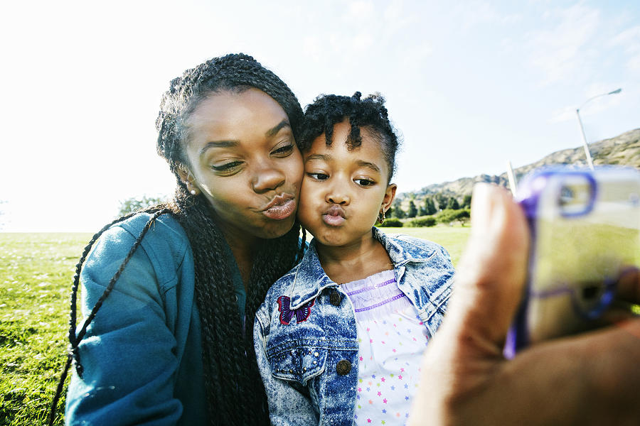 Black mother and daughter taking selfie outdoors Photograph by Peathegee Inc