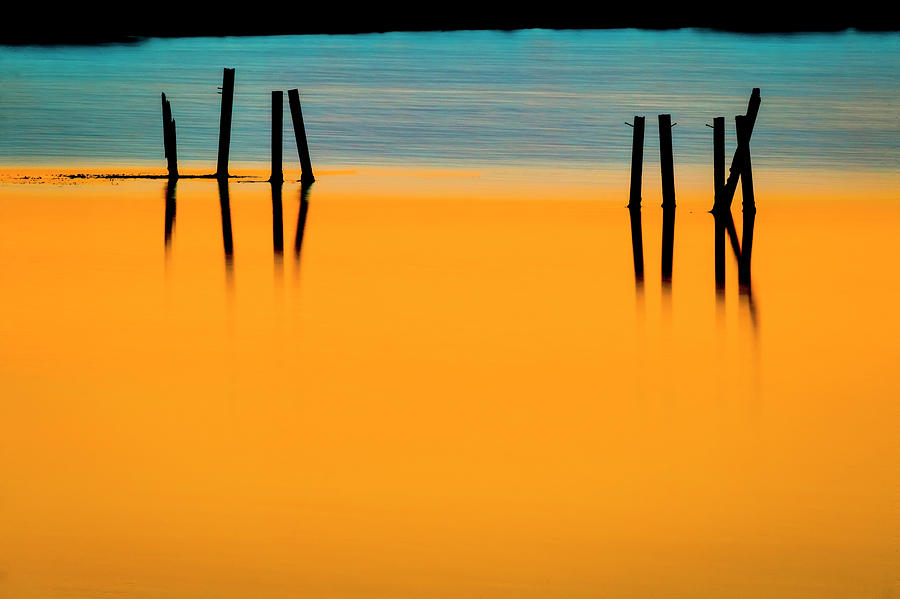 Black Pilings Orange Water X100 Photograph by Rich Franco