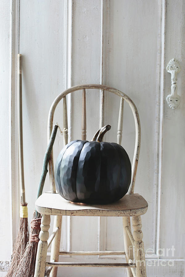 Black pumpkin on old chair Photograph by Sandra Cunningham