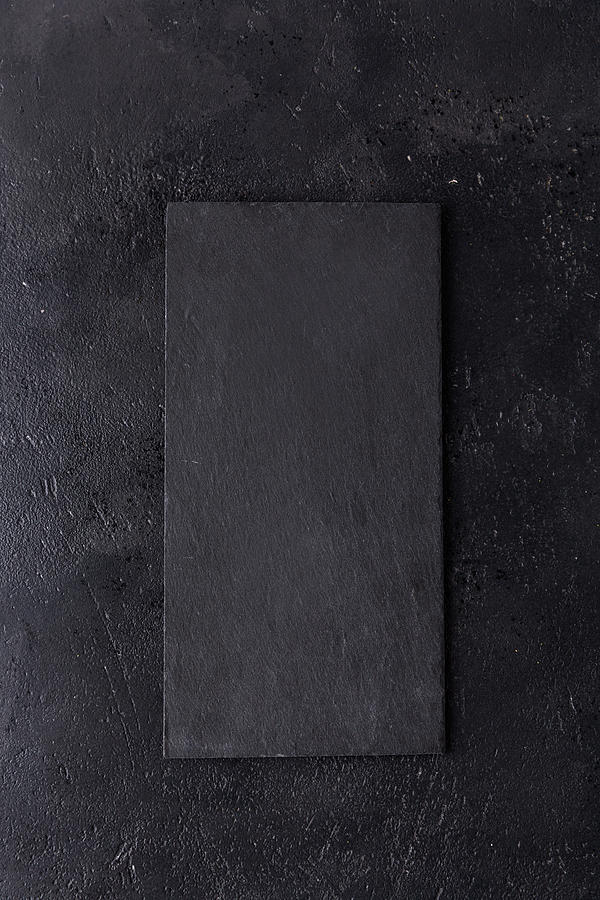 Black Slate Stone Cutting Board On Wooden Background Photograph by Yulia Naumenko