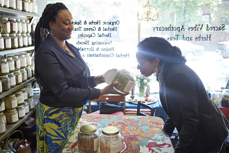 Black woman smelling tea in tea shop Photograph by Granger Wootz