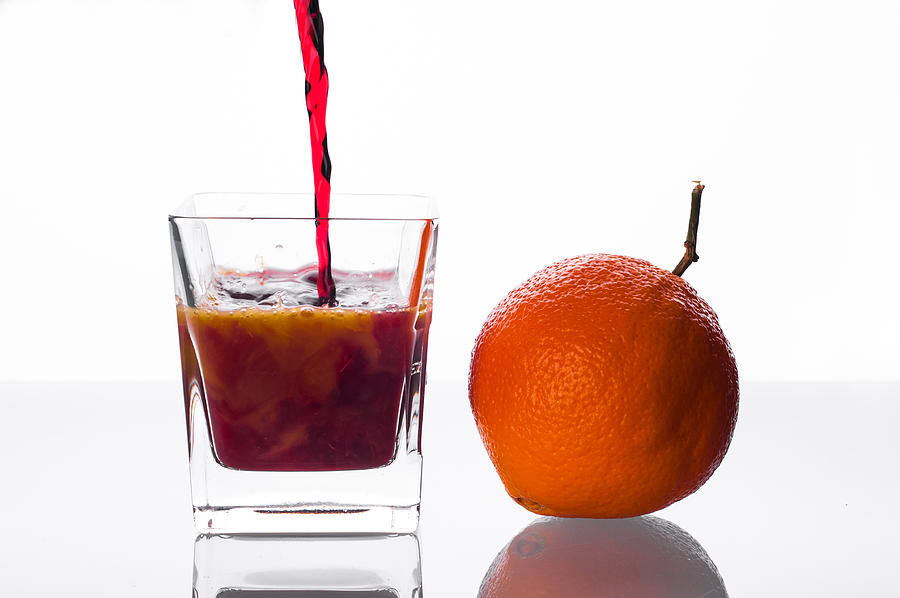 Blackcurrant Juice Pouring Into Glass With Orange Juice Photograph by MichalDziedziak
