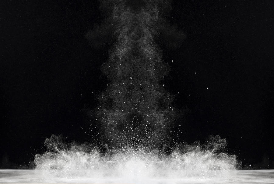 Blackground of particles of white powder in ascending movement floating in the air Photograph by Jose A. Bernat Bacete
