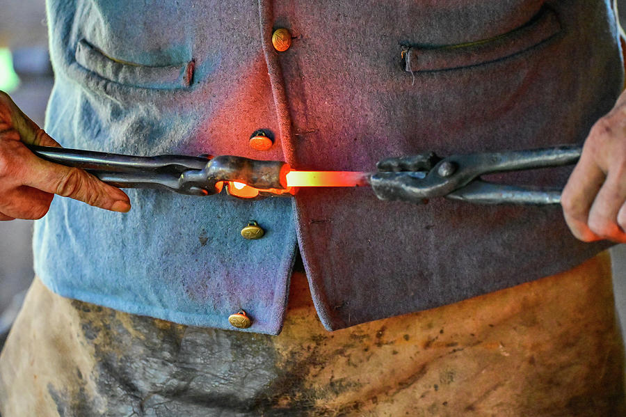 Blacksmith and molten metal Photograph by Ed Stokes