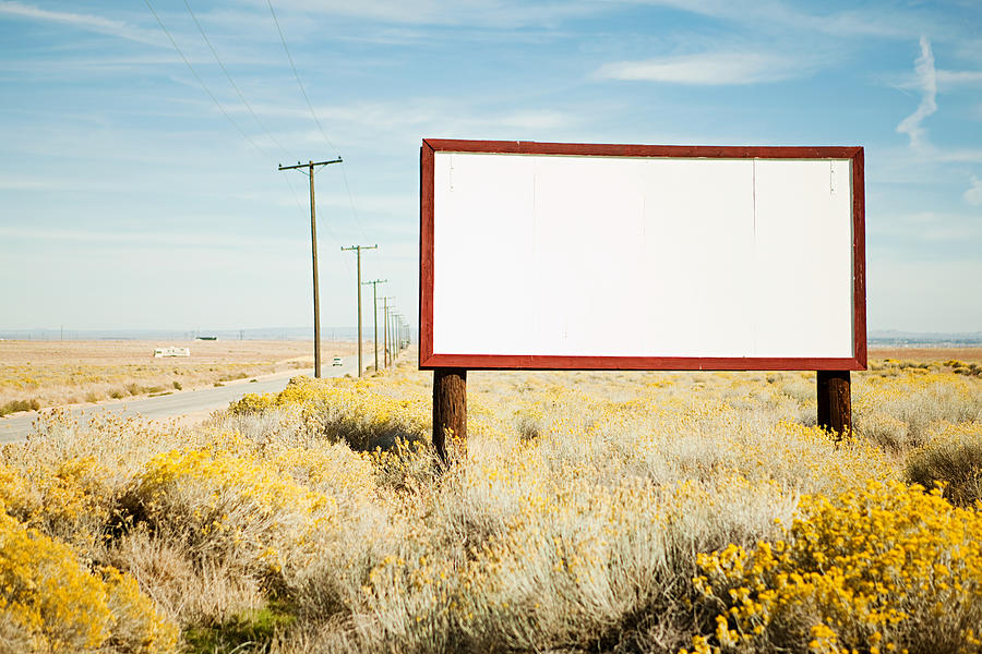 Blank billboard at roadside Photograph by Image Source