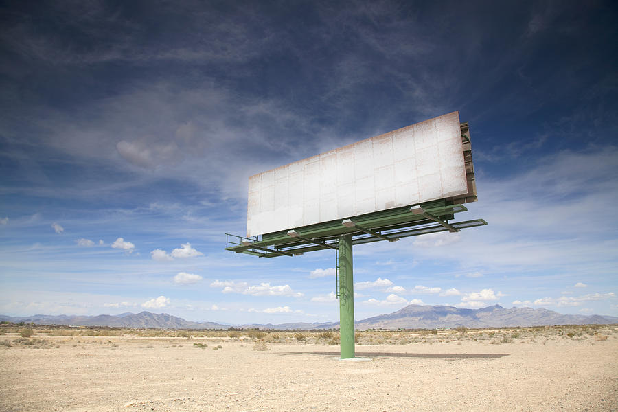 Blank billboard in desert Photograph by Grant Faint