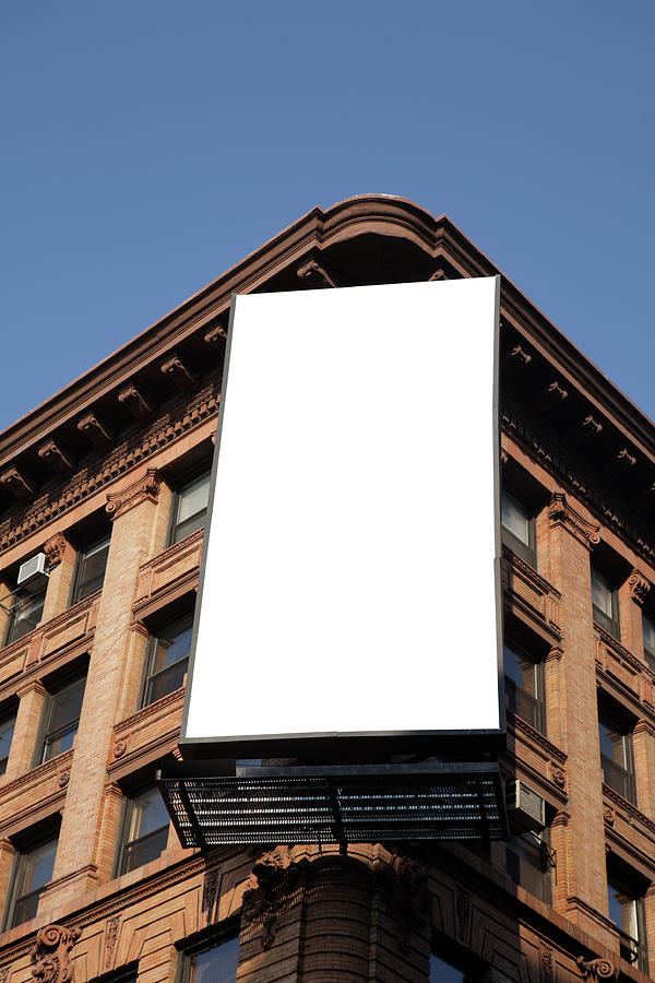 Blank billboard on the corner of an apartment block Photograph by Belterz