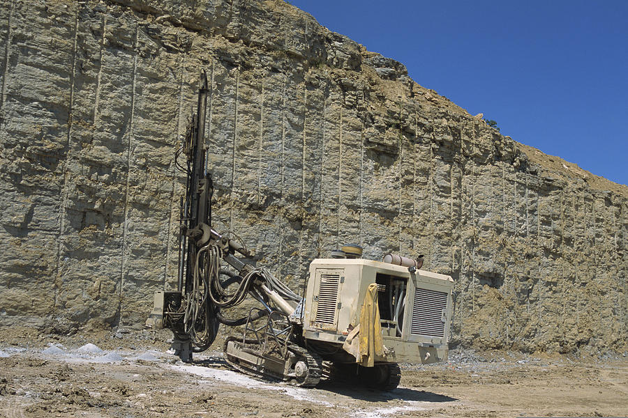 Blast hole drill  digging through rock wall Photograph by Comstock Images