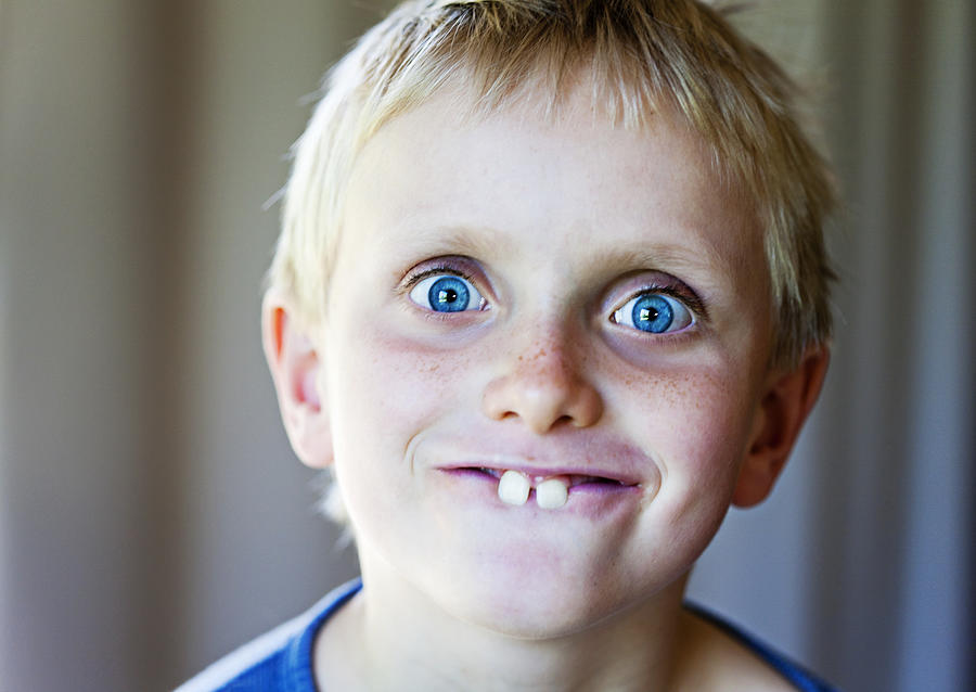 Blond 8 year old boy makes funny Bugs Bunny face Photograph by RapidEye