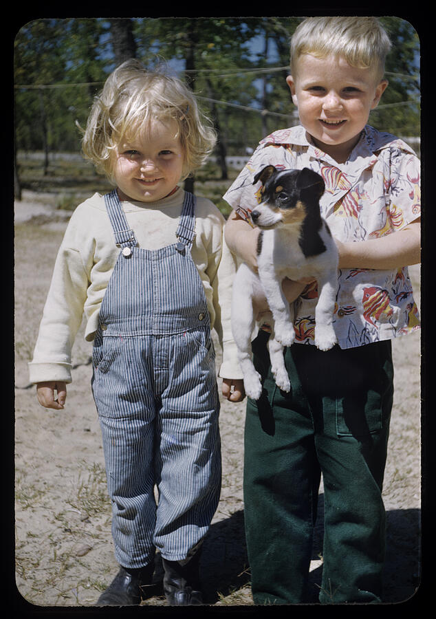 Blonde chubby toddlers hold puppy Photograph by Marcy Maloy
