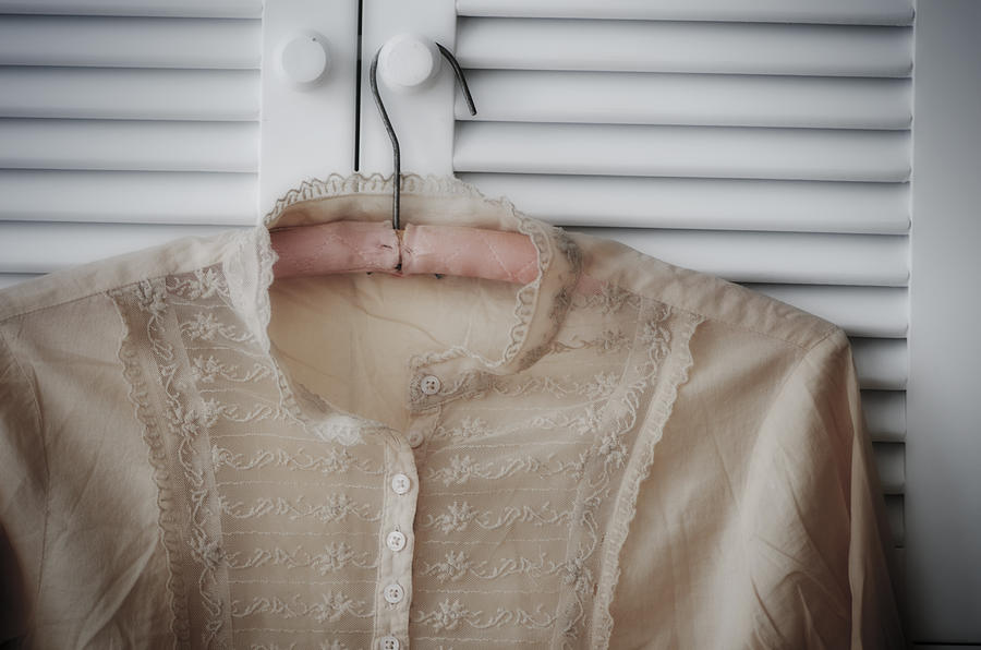 Blouse hanging on wardrobe door Photograph by Tetra Images