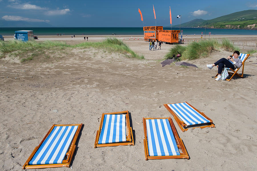 Blue and white striped folding beach chairs collapsed on the san Photograph by David L Moore