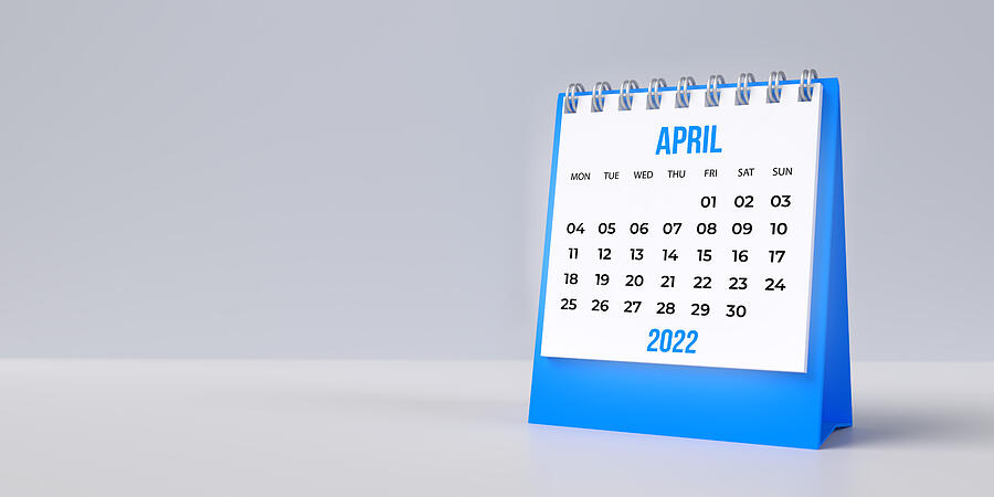 Blue April desk calendar 2022 on blank background with copy space. Photograph by Photoman