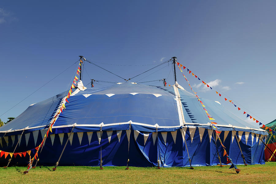 Blue Circus Tent In A Park With Colorful Pennants Under The Ligh 