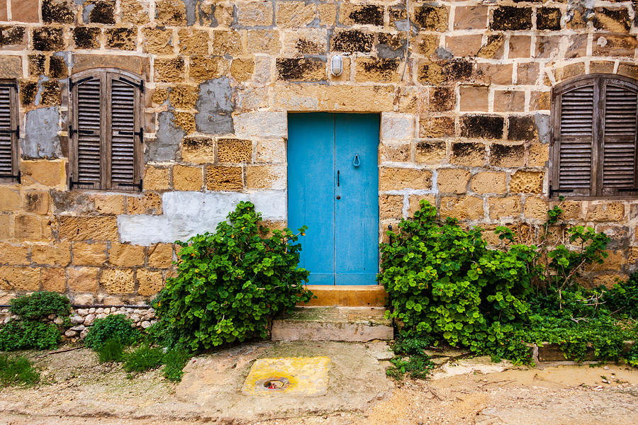 Blue door in a weathered house, in Gozo, Malta Photograph by Flottmynd