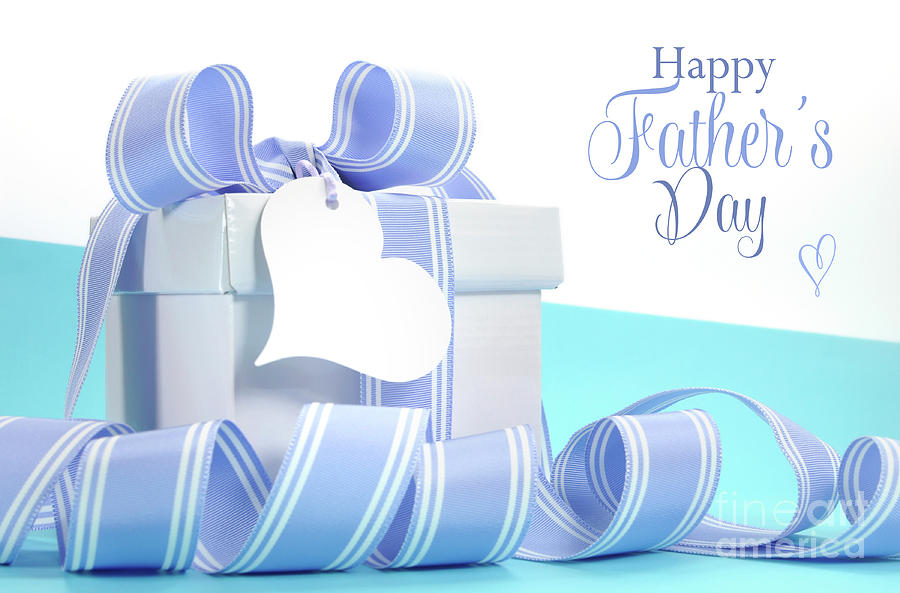 Blue Fathers Day gift with beautiful stripe ribbon and heart shape gift tag Photograph by Milleflore Images