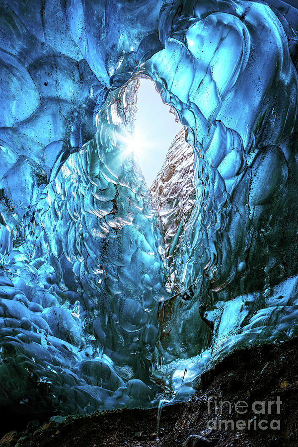 Winter Photograph - Blue glacial ice with hole through to the sky with sun burst, fr by Jane Rix