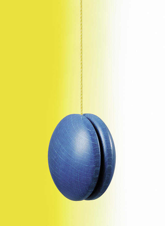 Blue hanging yo-yo on white and yellow background Photograph by DarioEgidi