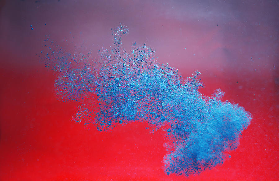 Blue ink cloud on red background Photograph by Stanislaw Pytel