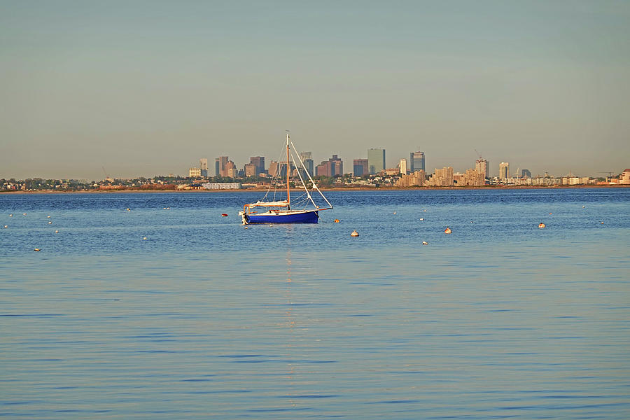 Blue Sailboat and the Boston Skyline from Swampscott Massachusetts Photograph by Toby McGuire