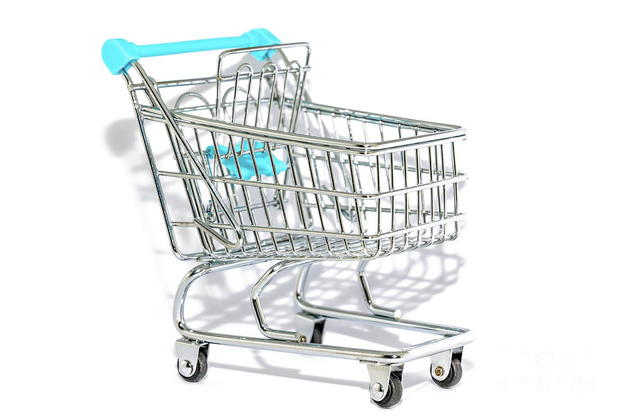 Blue shopping cart on white background Photograph by Benny Marty