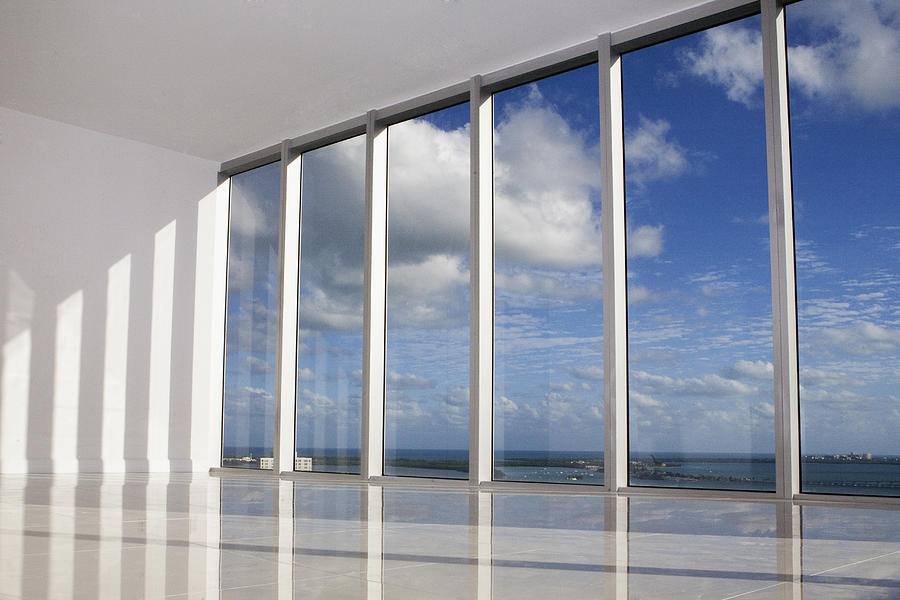 Blue sky viewed through windows in modern apartment Photograph by Camilo Morales