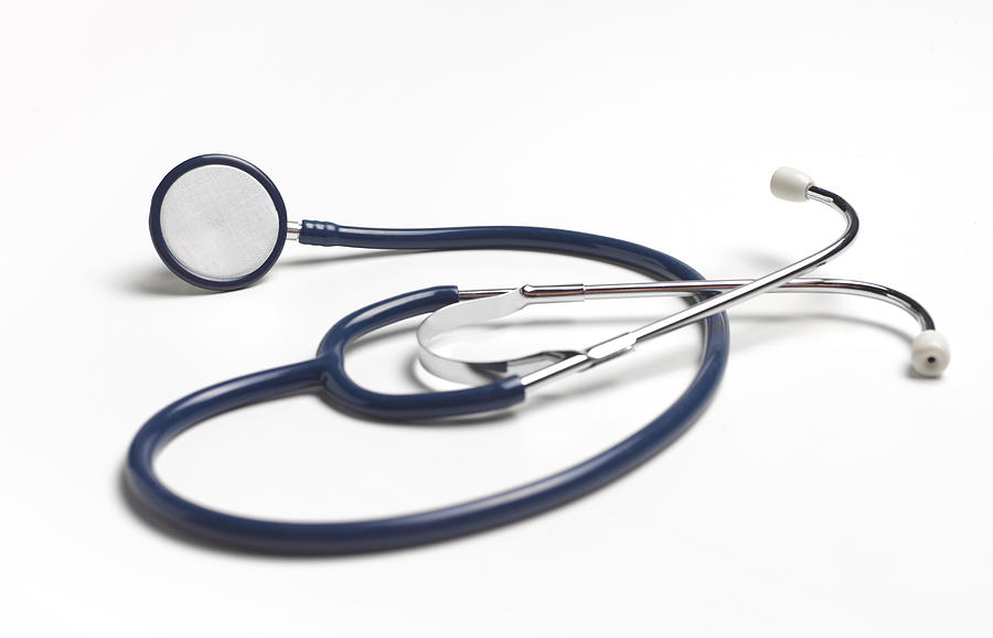 Blue stethoscope on white background Photograph by Peter Dazeley