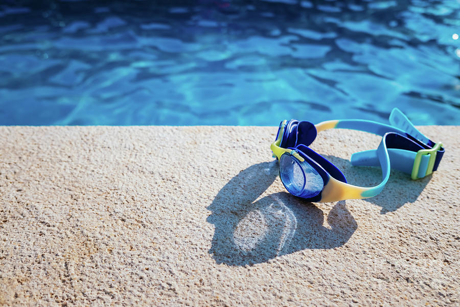 Blue Swimming Pool Goggles Illuminated By The Summer Sun On The Photograph