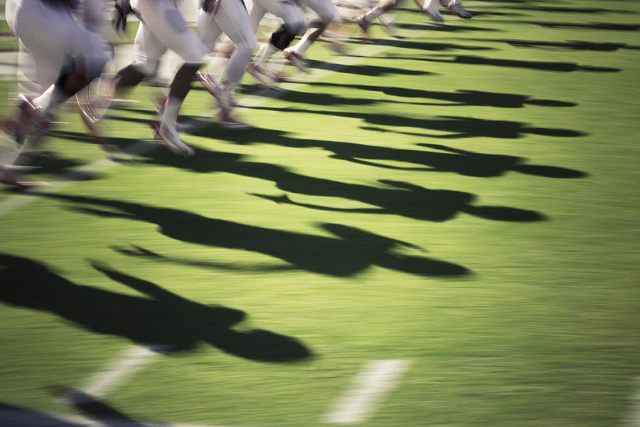 Blur of American football players. Photograph by David Madison