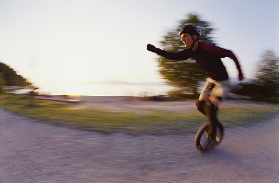 Blurred Motion Shot of a Man Riding a Monocycle Photograph by Darryl Leniuk