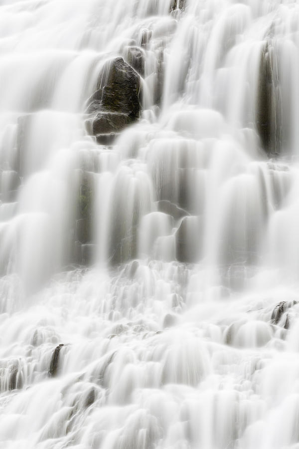 Blurred view of waterfall cascading over rock formations Photograph by Jeremy Woodhouse