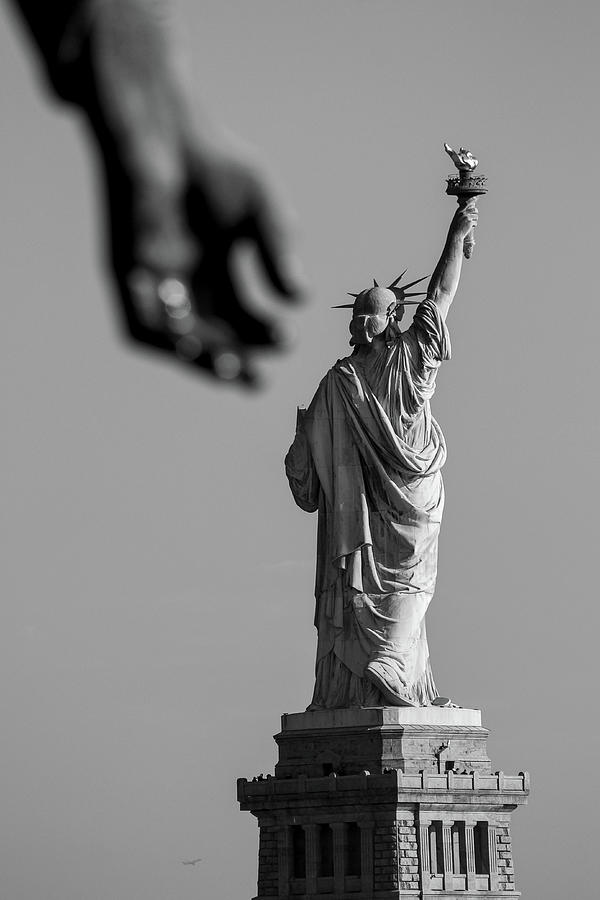 Blurry hand with the statue of liberty NY Photograph by Habib Ayat