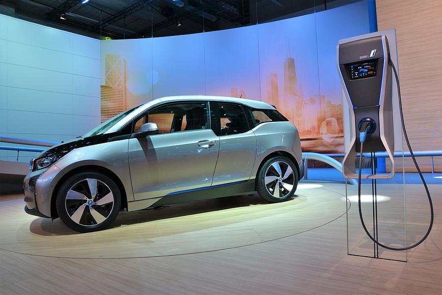 BMW i3 and electric charging point Photograph by Tramino