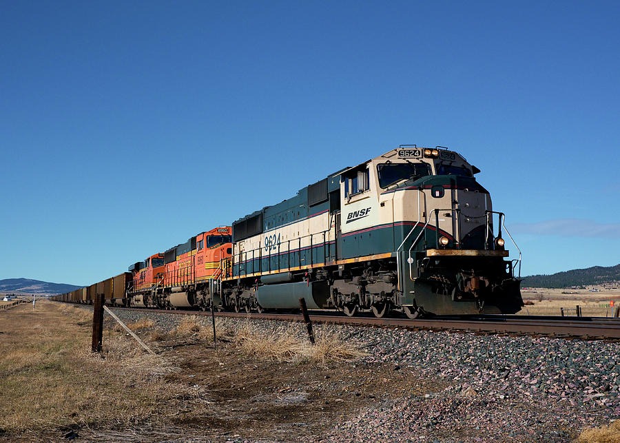 Blue and White BNSF Locomotive 9624 leads empty coal hoppers at Head Lane toward Helena Mt Photograph by Dutch Bieber
