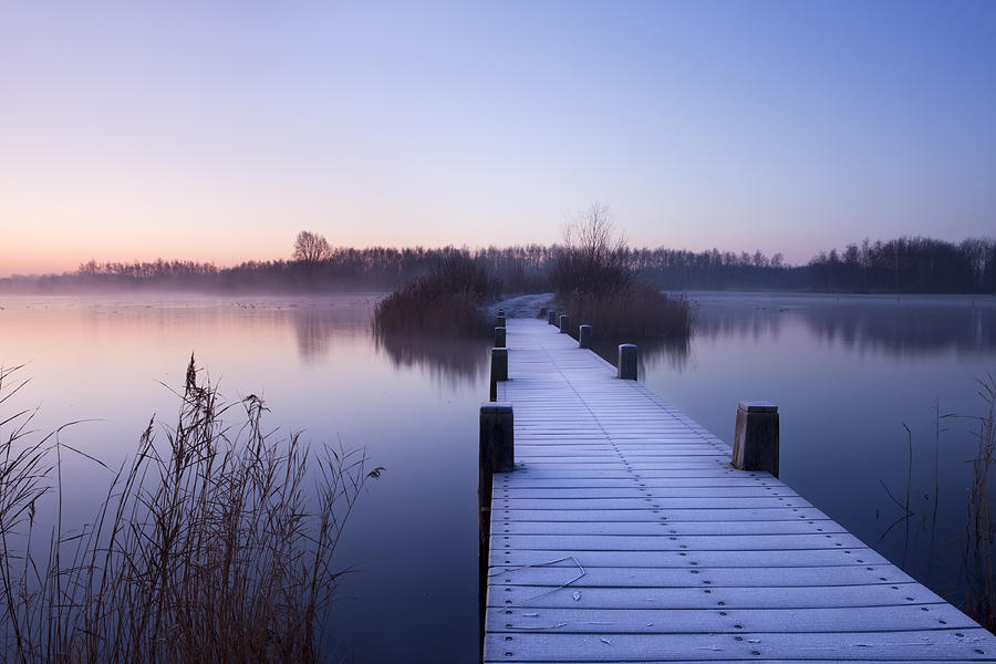 Boardwalk on a lake at dawn in winter, The Netherlands Photograph by Sara_winter