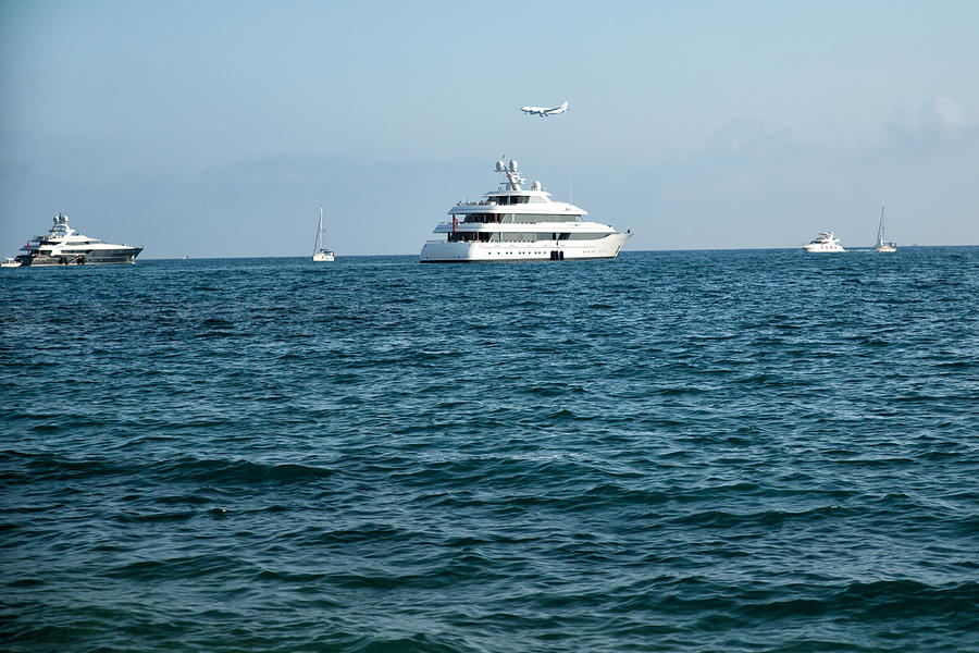 Boat and air plain on the sea Photograph by Jean-Marc PAYET