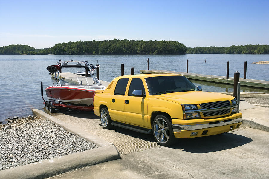 Boat and truck on boat launch Photograph by Thinkstock