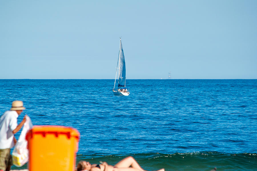 Boat background and woman sunbathing on the beach Photograph by By Ronaldo Melo