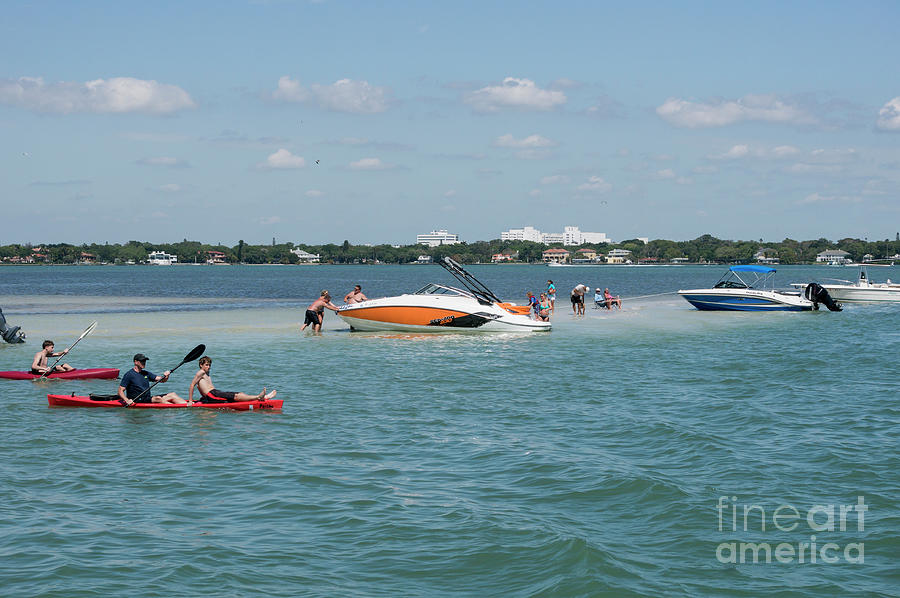 Boaters relax on a sand bar as kayakers paddle by in Sarasota Ba Photograph by William Kuta