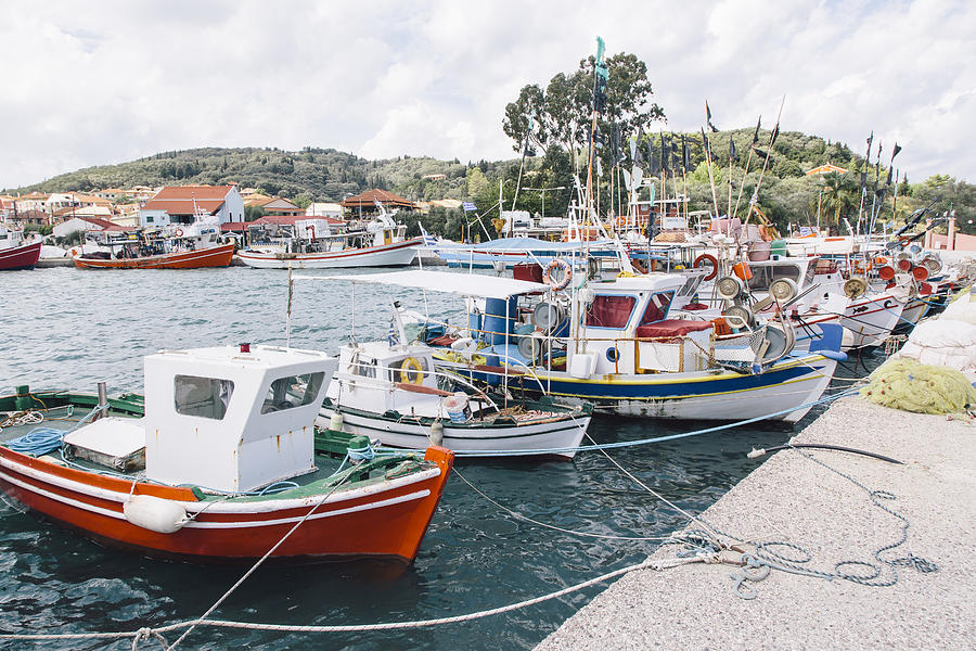 Boats moored at the harbor in fishing village Petriti on Corfu island, Greece Photograph by Alexander Spatari