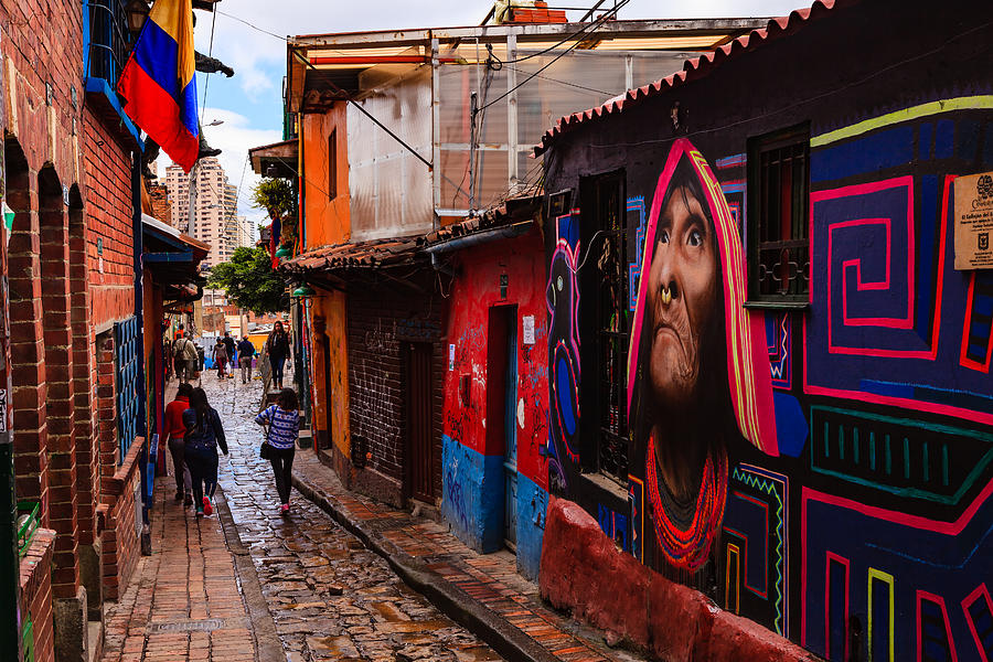 Bogotá, Colombia - People Walk Through The Narrow, Colorful, Cobblestoned Calle del Embudo In The Historic La Candelaria District Photograph by Devasahayam Chandra Dhas