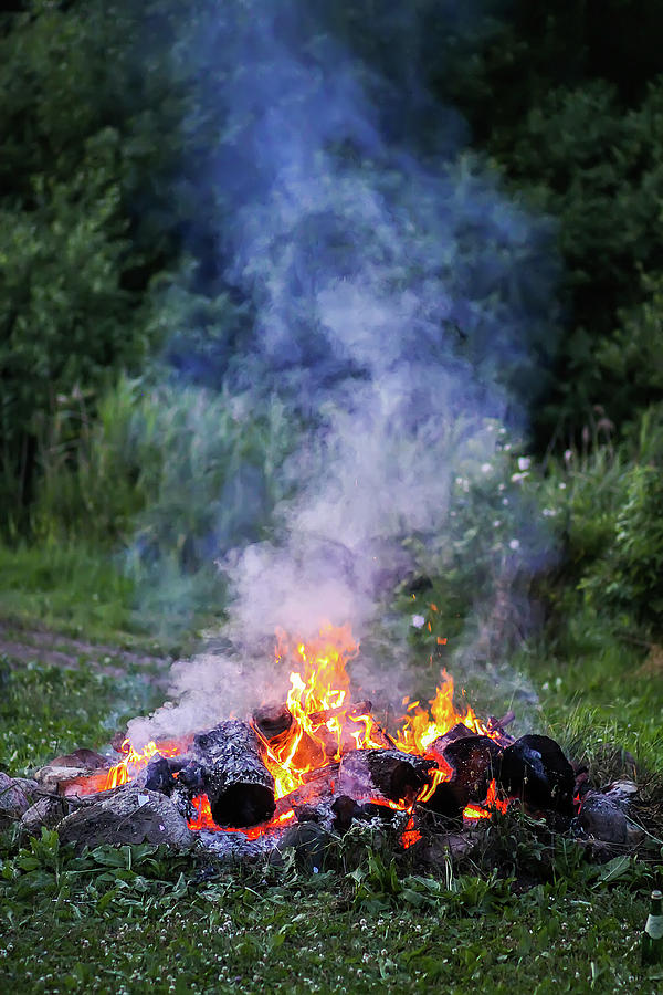 Nature Photograph - Bonfire at a camp in summer evening outdoors by Olga Strogonova