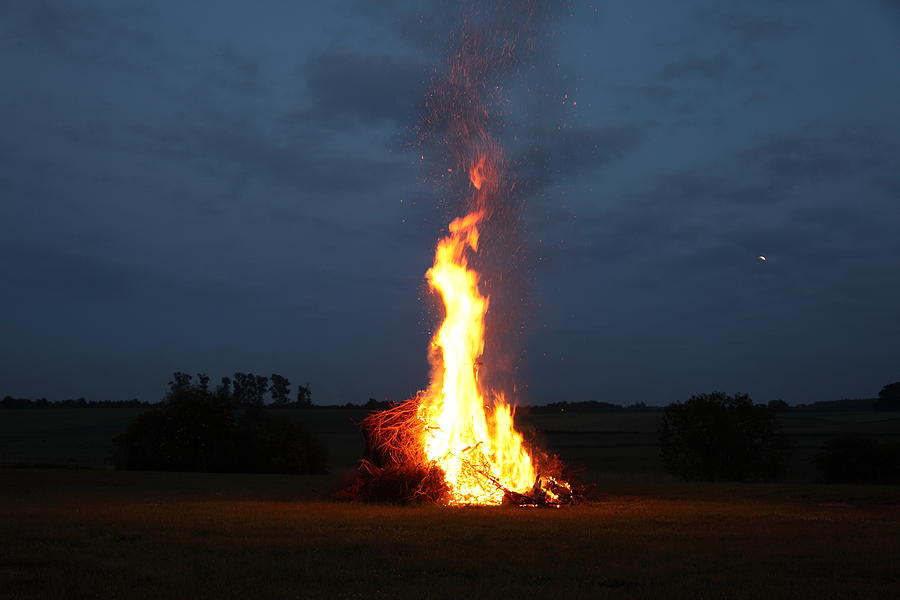 Bonfire at midsummer with moon in the sky Photograph by Pejft