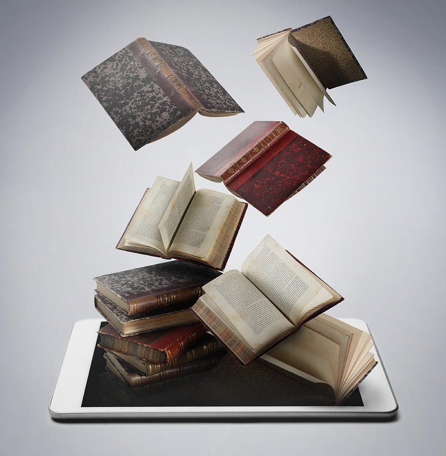 Book and digital tablet Photograph by Yagi Studio