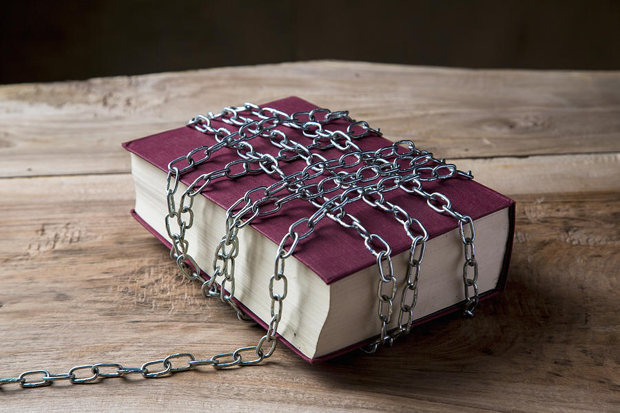 Book with chains wrapped around it Photograph by Guido Cavallini