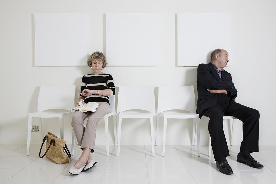 Bored senior man & woman in a waiting room Photograph by Andrew Bret Wallis