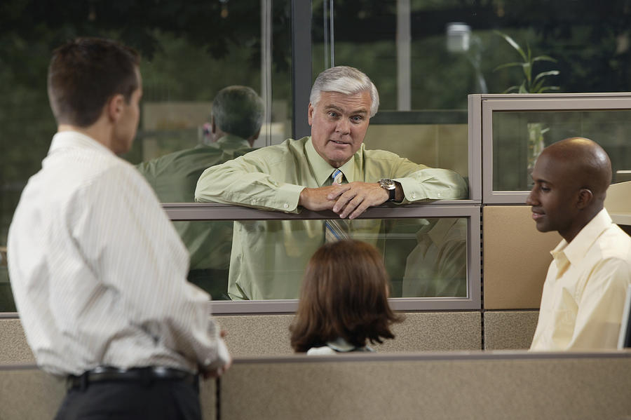Boss talking to employees Photograph by Comstock Images