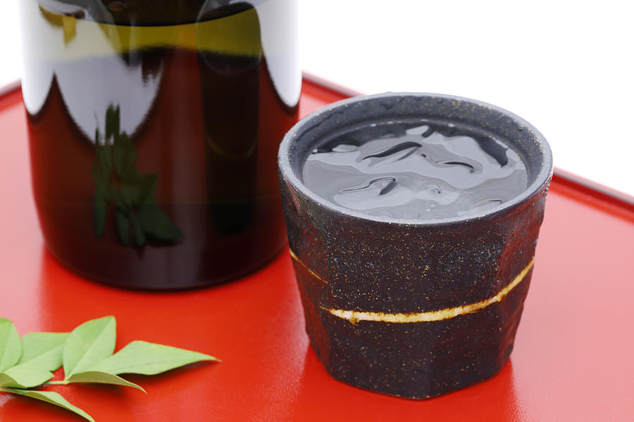 Bottle of Japanese shochu and ceramic bowl Photograph by Akiyoko