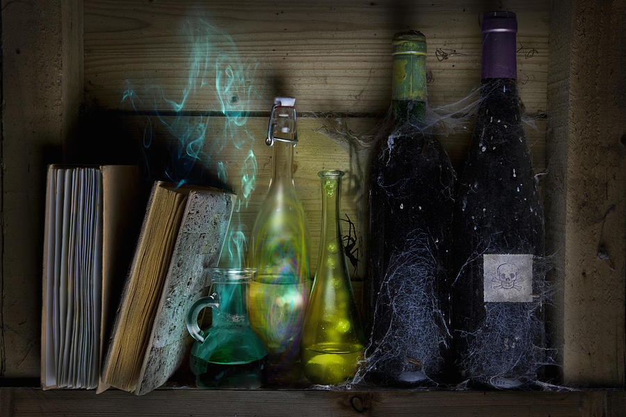 Bottles of spells and potions and books of magic Photograph by Andrew Bret Wallis