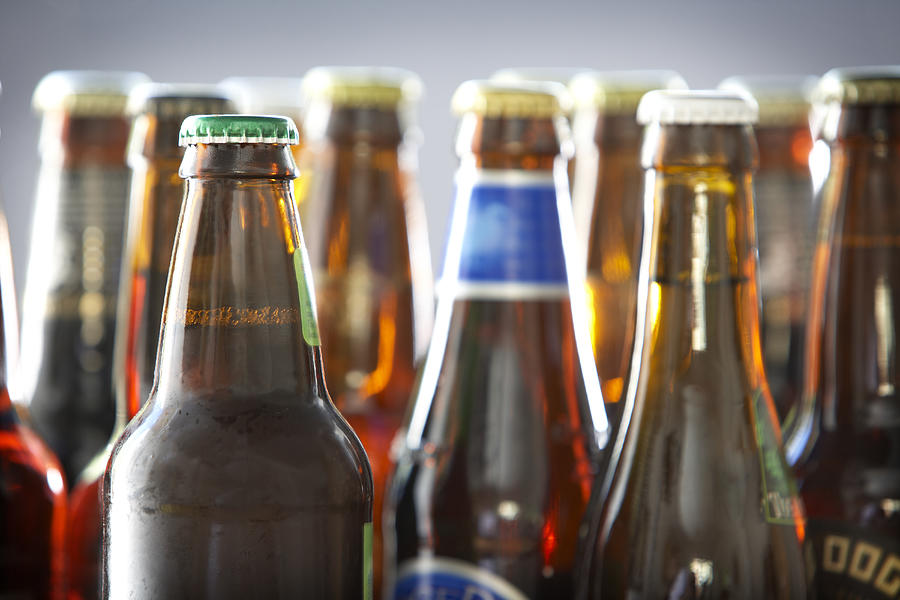 Bottles of various bottled beer in studio Photograph by Michael Cogliantry